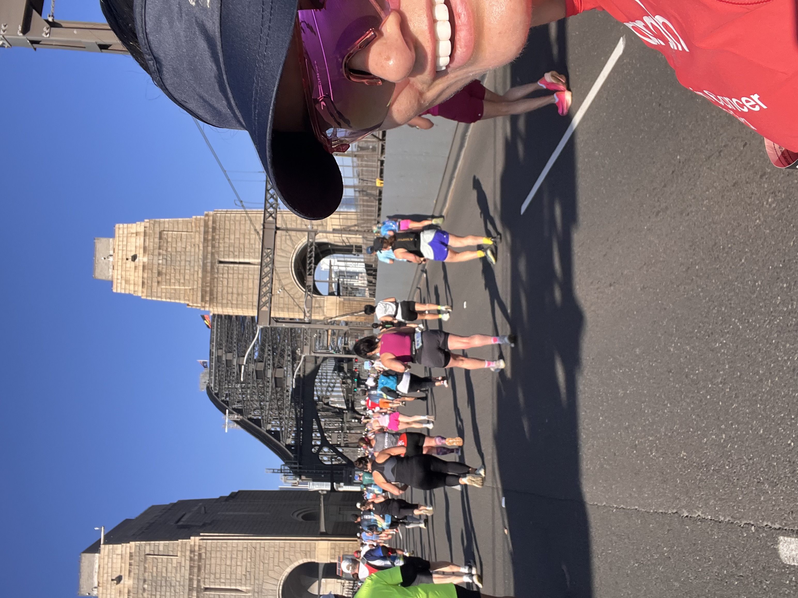 Runner in a Brain Cancer Australia singlet crossing the Sydney Harbour Bridge during the Sydney Marathon